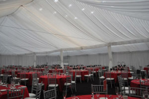 event tables and chairs inside white tent